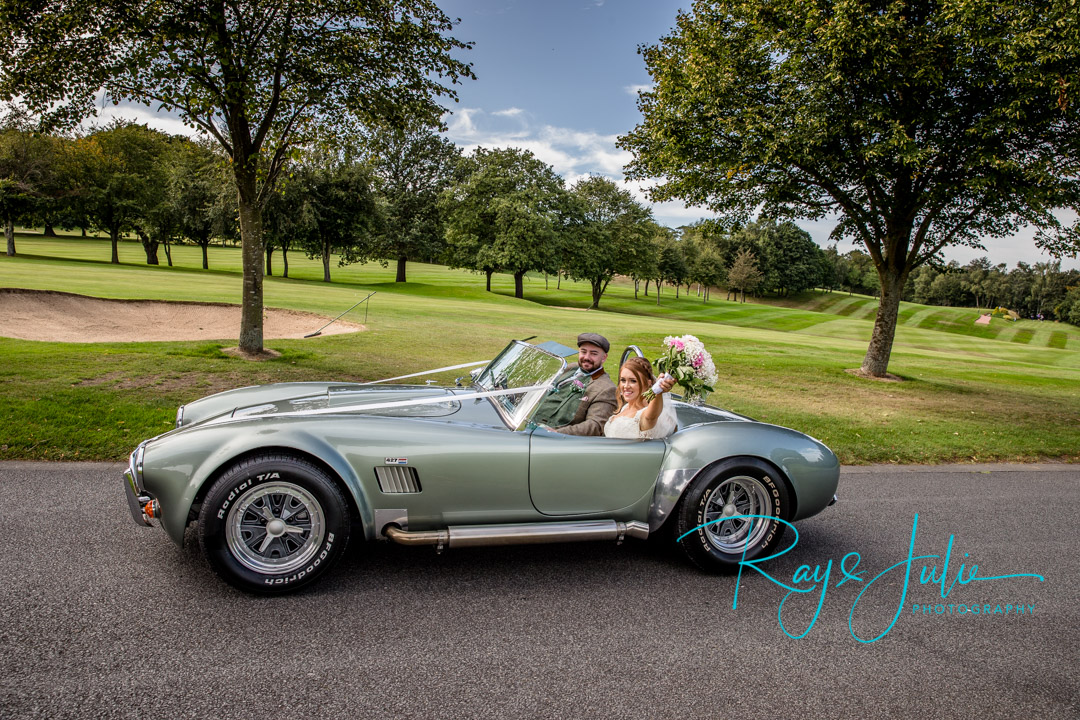 Bride and groom in a AC Cobra RAM 5.7 V8 1973 classic car at their Woodsome Hall Wedding