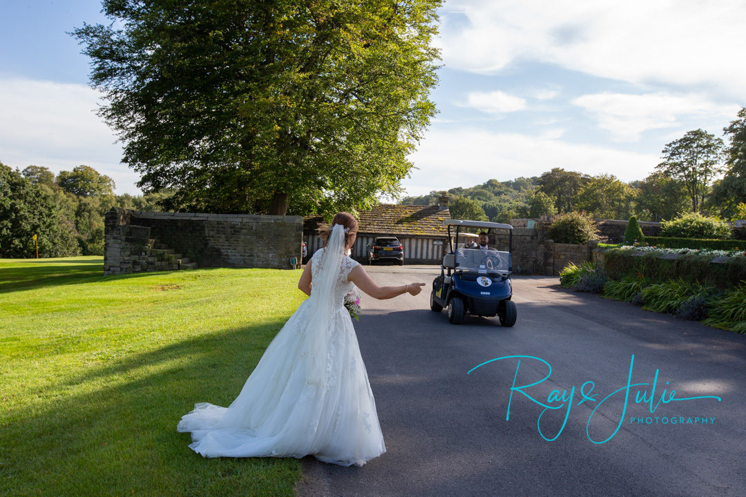 Bride hitchin a lift from groom in a golf buggy at Woodsome Hall