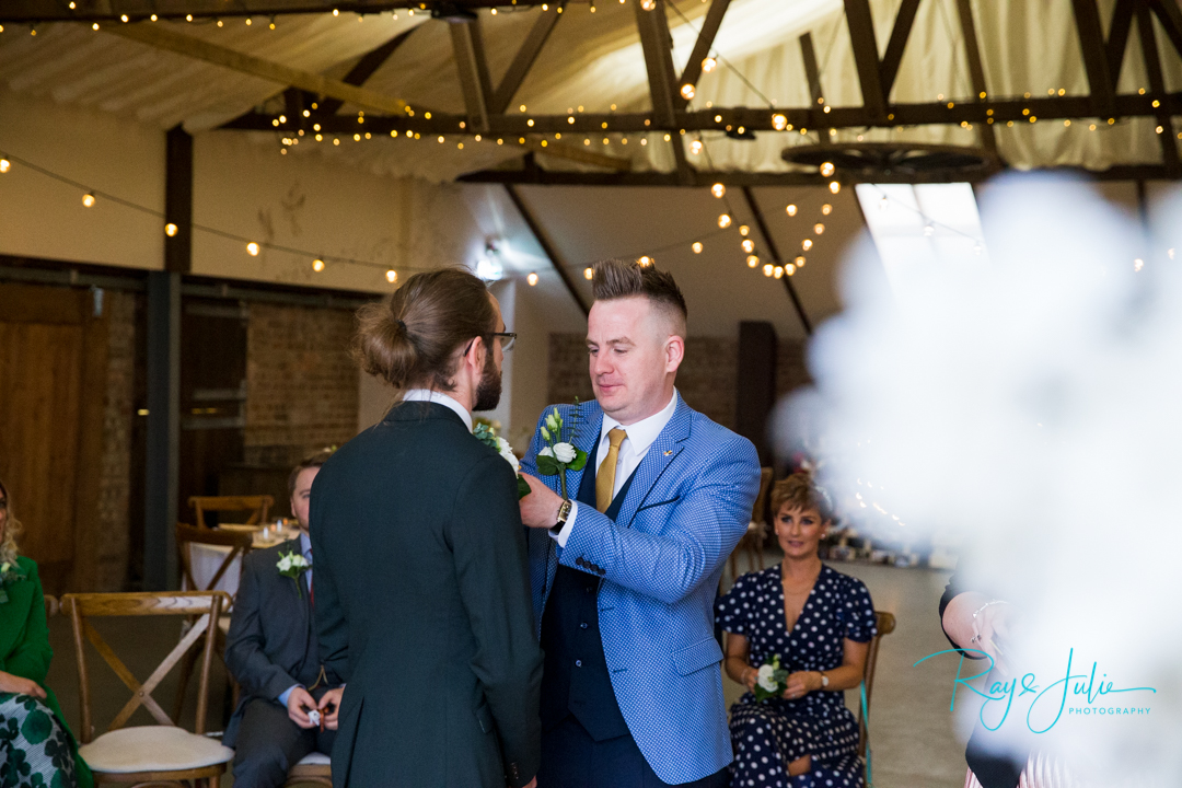 Best man adjusting grooms tie