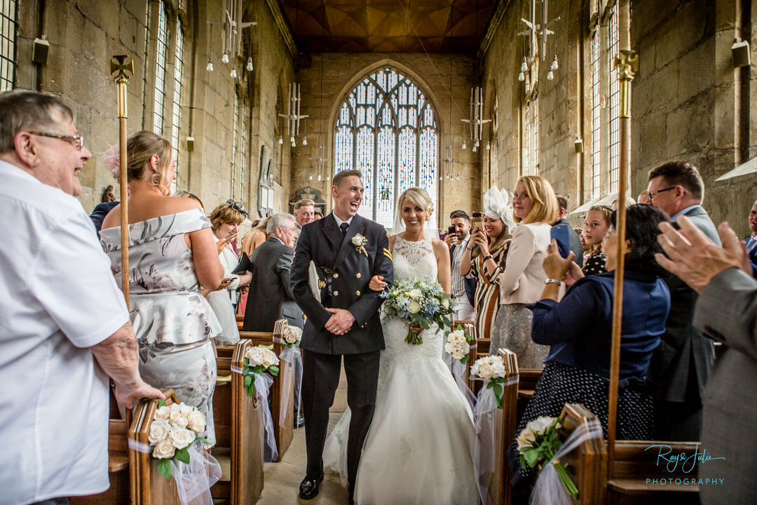 Military church wedding bridal procession leaving church smiling