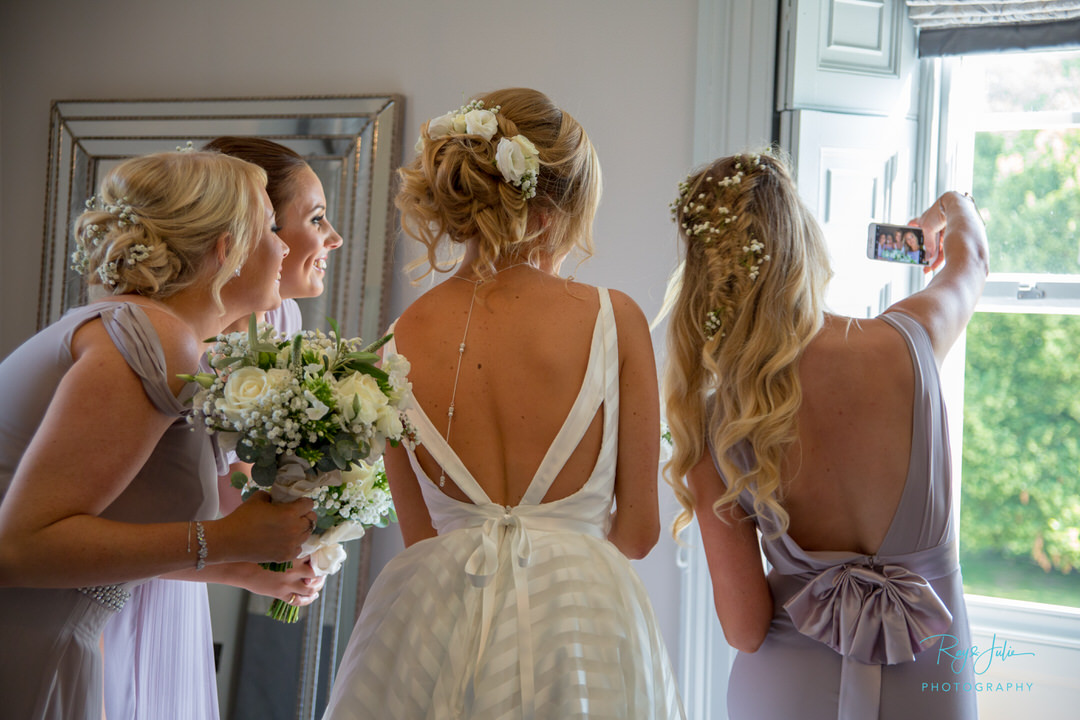 Bride at Saltmarshe Hall having a selfie with bridesmaids