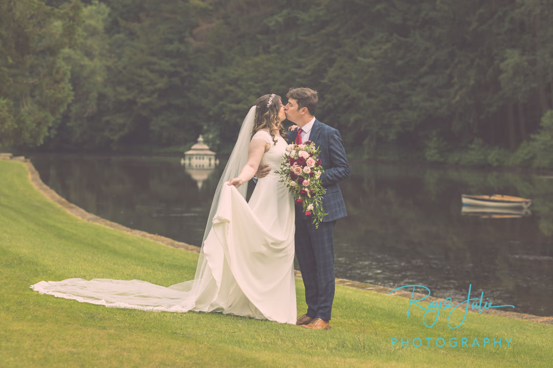 Wedding couple kissing in the grounds at Grantley Hall