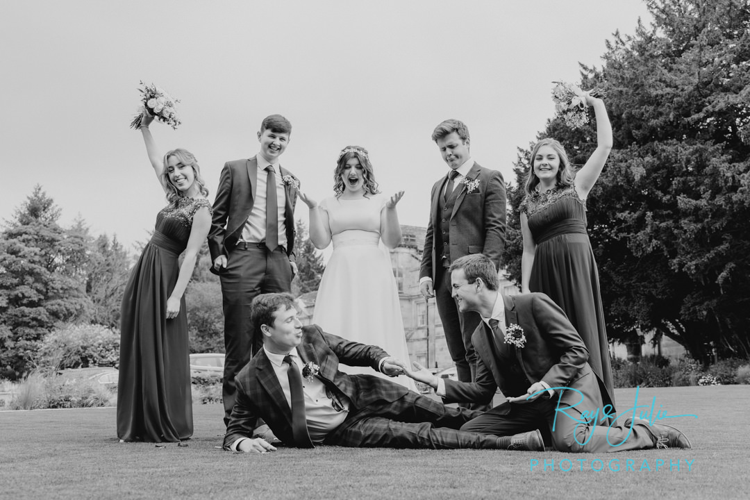 Bridal party having fun outside Grantley Hall