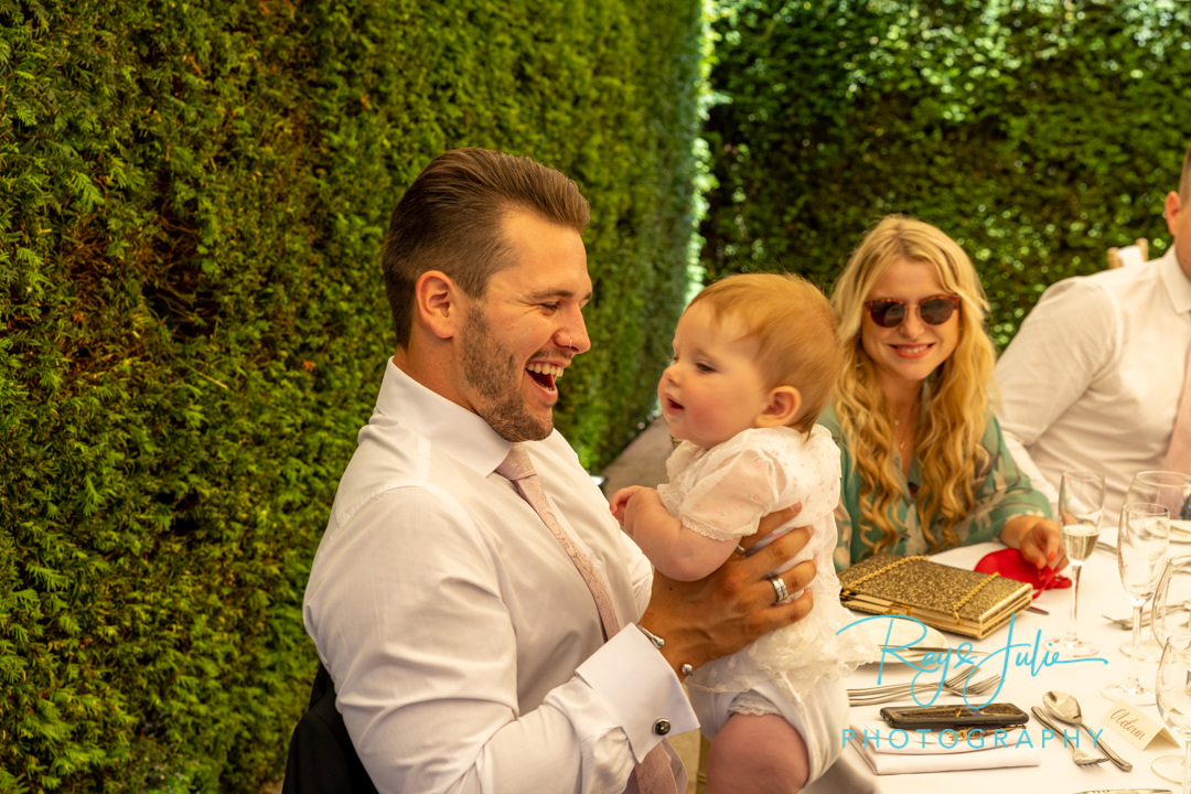 Groomsmen and baby at wedding reception table at Saltmarshe Hall