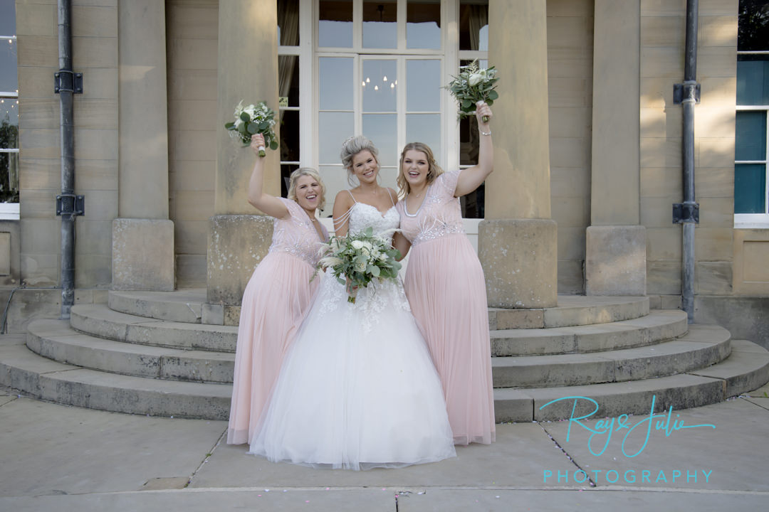 Bride with bridesmaids outside the front entrance of Saltmarshe Hall. Flowers by All Occasions