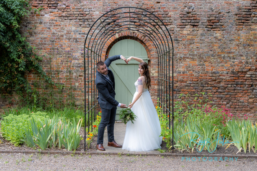 Bride and Groom make love heart shape