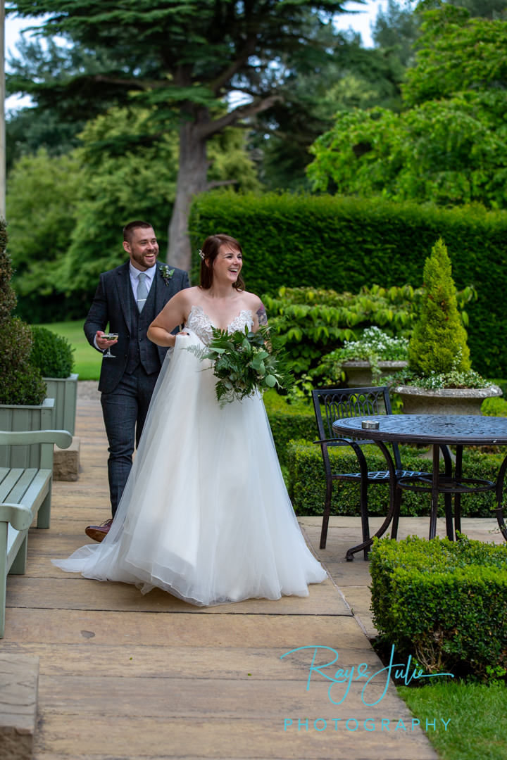 Bride and Groom smiling as they return for wedding reception