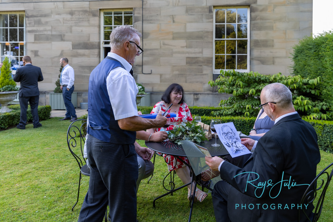 Wedding guest receiving caricature of himself