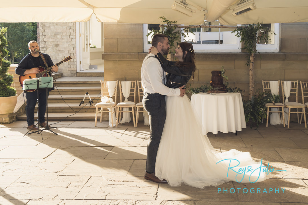 First dance outdoor with singer in the background