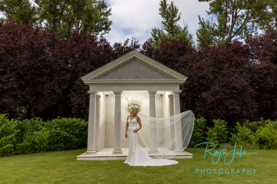 Stunning bride in wedding dress with Tickton Grange feature behind.