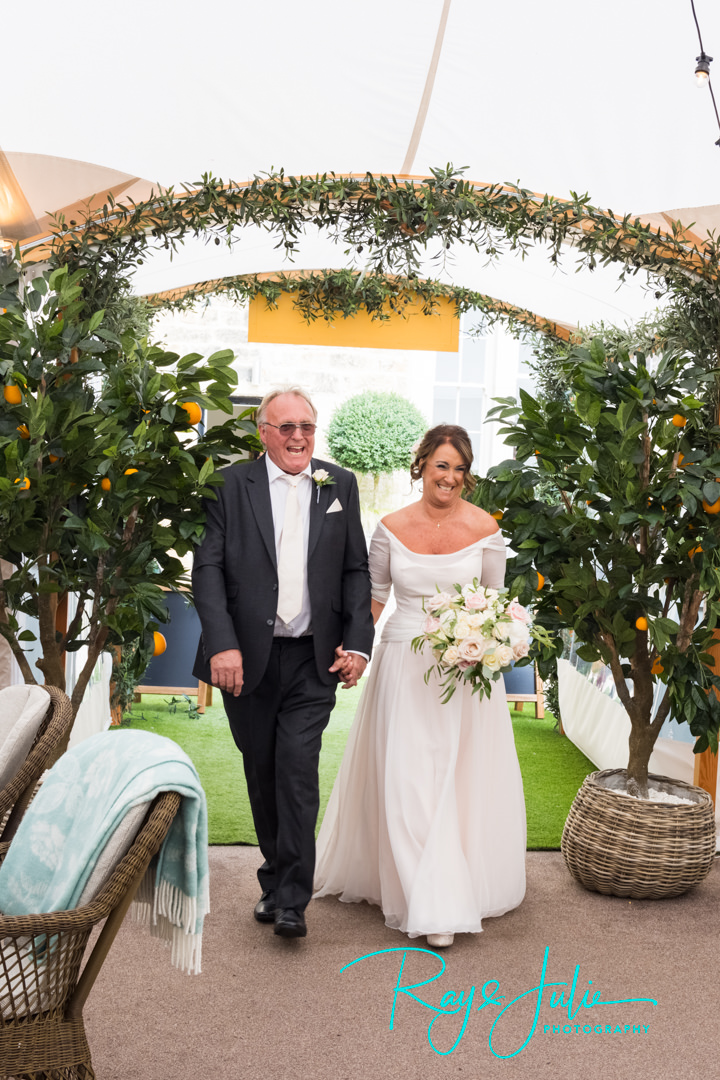 Bride and groom making their entrance into The Orchard at Grantley Hall