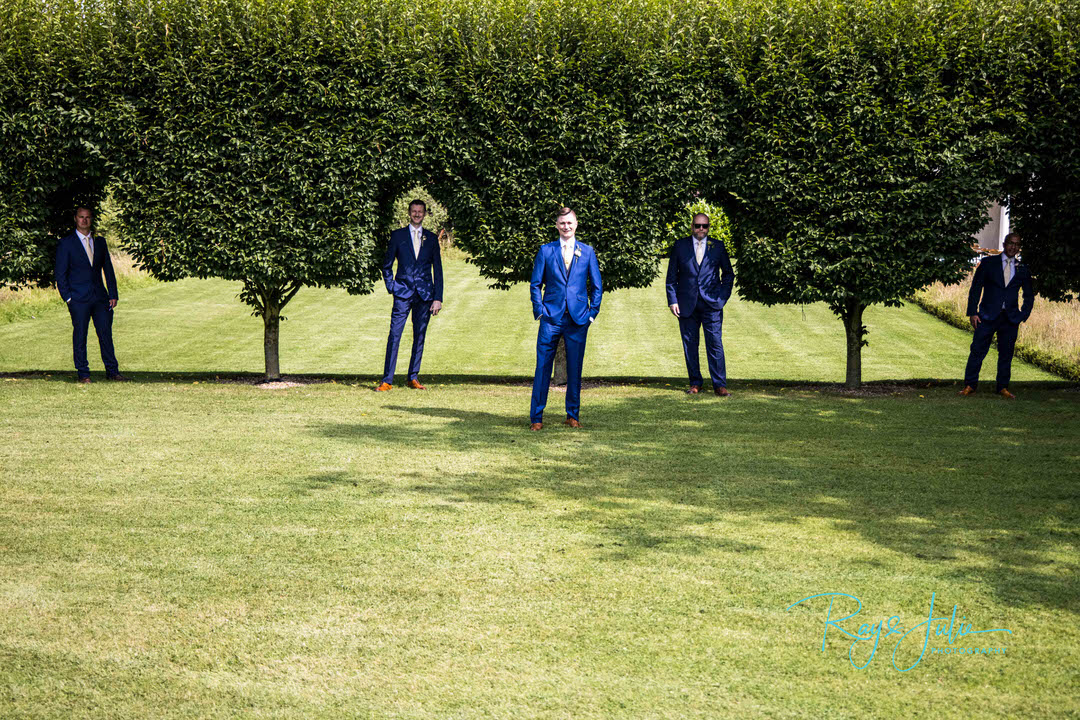 Groom and groomsman in background at Tickton Grange