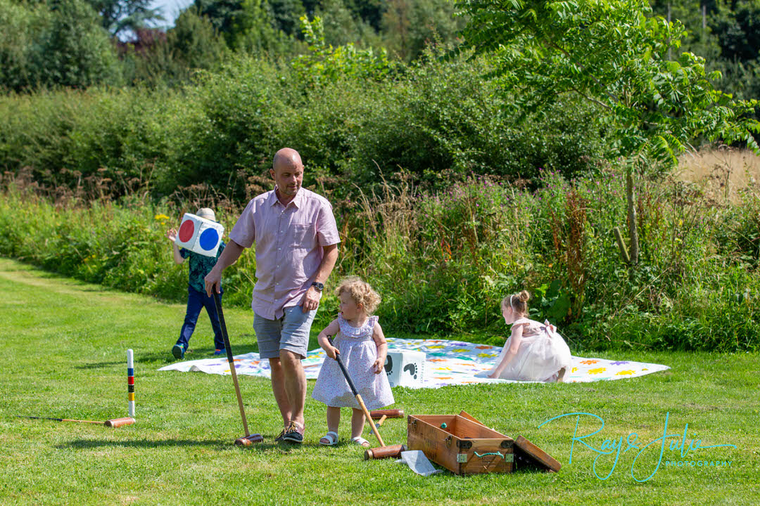 Children playing outdoor games at a wedding