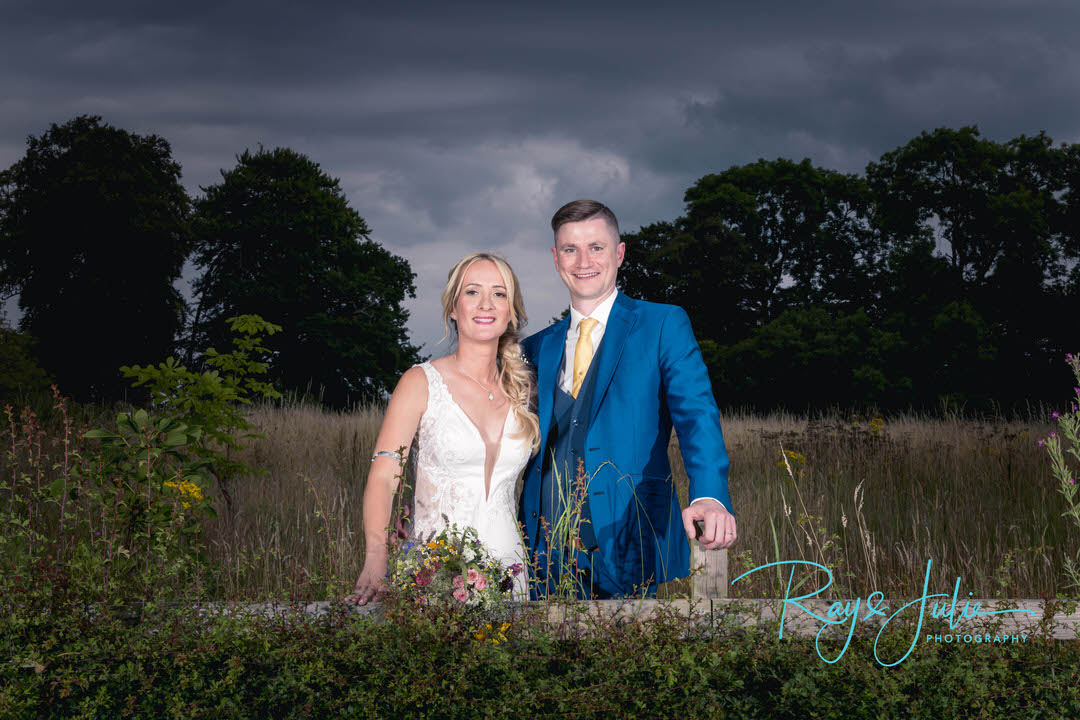 Bride and groom outdoor bridal portrait dramatic sky