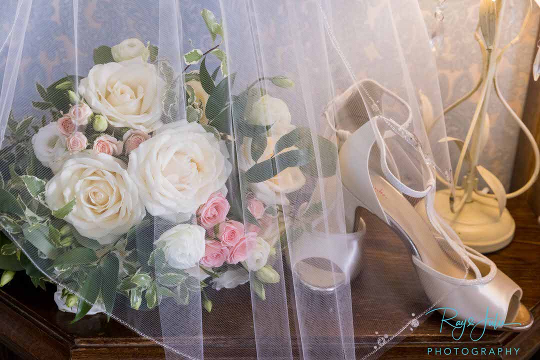 Brides wedding shoes veil and flowers