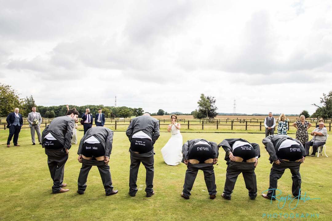 Groom with writing on boxer shorts showing bride