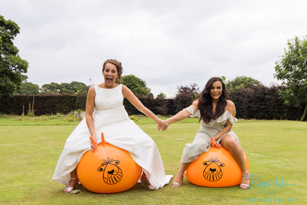 Bride and daughter on space hoppers 