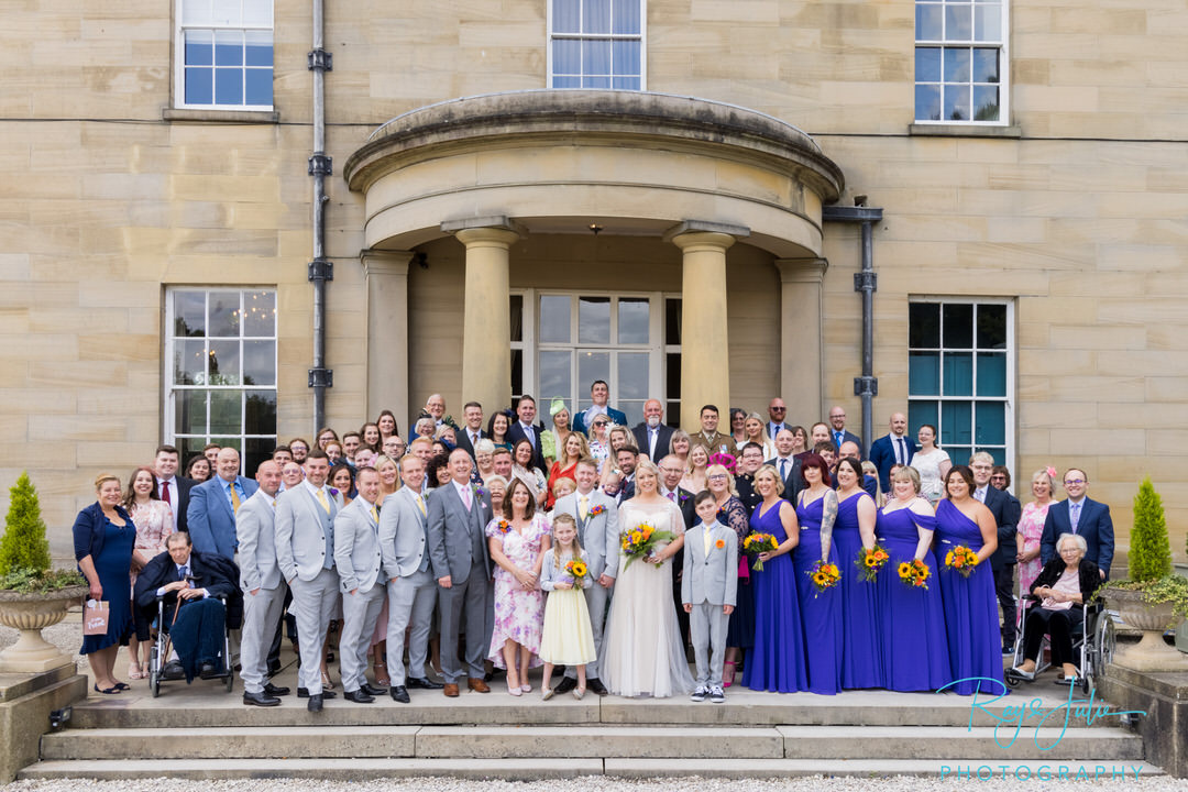 Large wedding group portrait at the front of Saltmarshe Hall